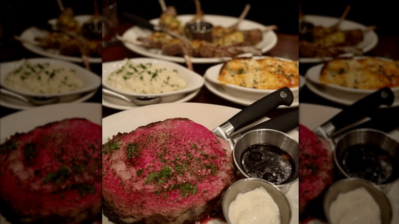 Several plates of food, including steak and mashed potatoes, at Sperry's