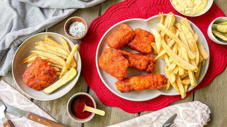 Nashville hot fish and chips on serving platter and plate with condiments