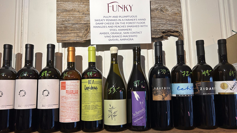 shelf of natural wine and funky sign