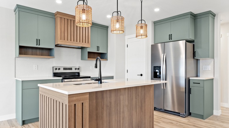 Modern kitchen with island, electric oven, and refrigerator