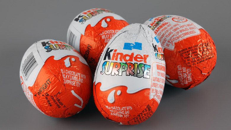 Four Kinder Surprise wrapped candies.