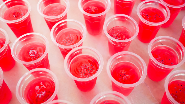 pink Jell-O shots in clear plastic cups