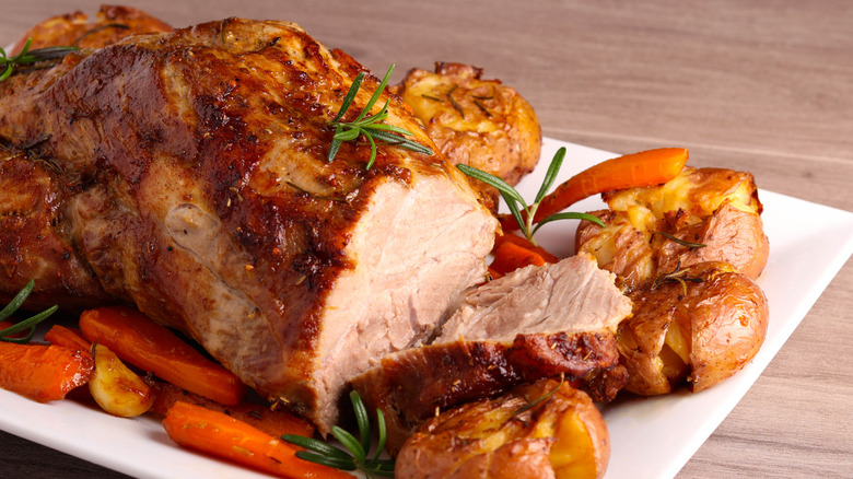 Pork roast with potatoes, carrots, and herbs