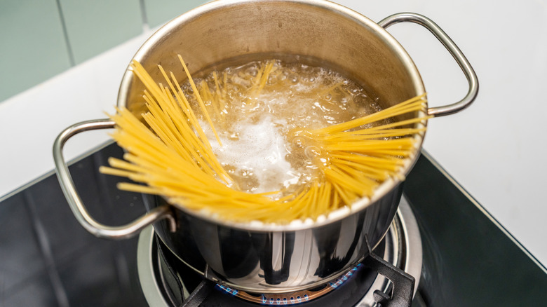 Spaghetti swirling in boiling water in a pot preparing a pasta