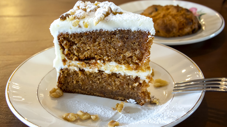 a piece of carrot cake with fork on white plate