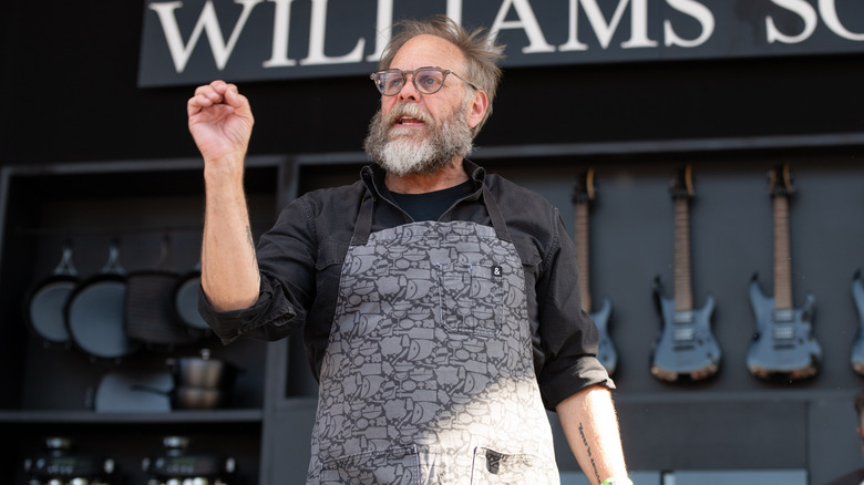 The Food Network personality Alton Brown appears on stage at an event.