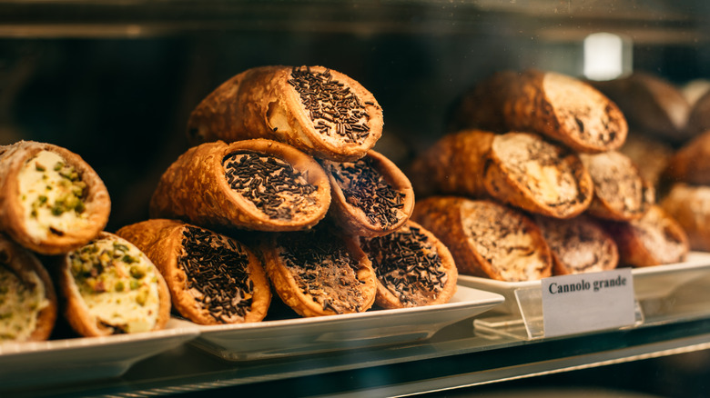 Cannoli behind a bakery counter