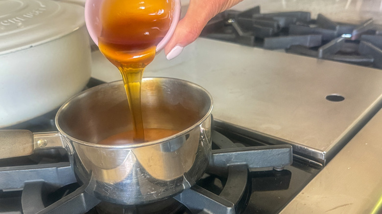 pouring honey into pot