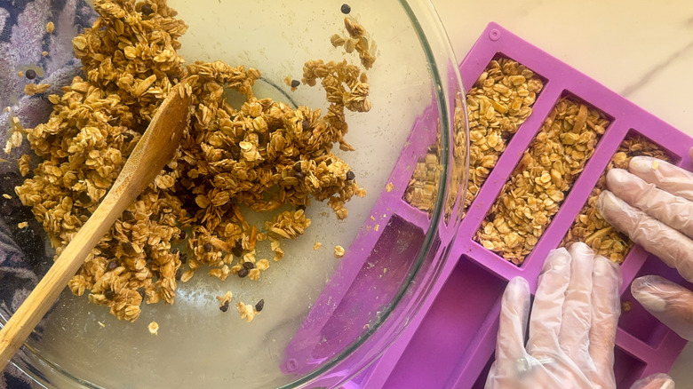 hands pressing mixture into mold