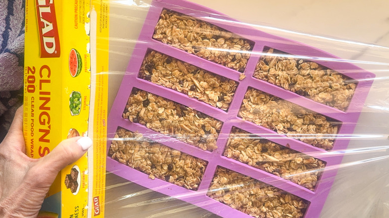 hands wrapping mold with wrap