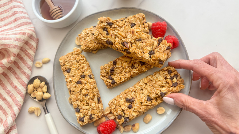 hand grabbing granola bar