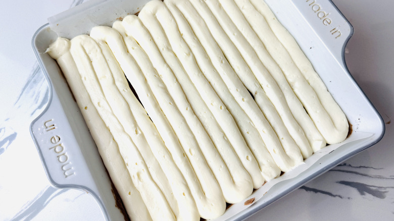 White chocolate cheesecake layer piped in pan