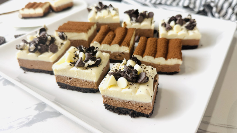 Triple chocolate cheesecake bars on serving plate