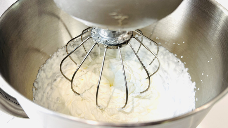 Whipped cream in mixing bowl