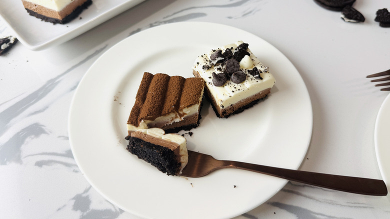 Bite out of no-bake triple chocolate cheesecake bars