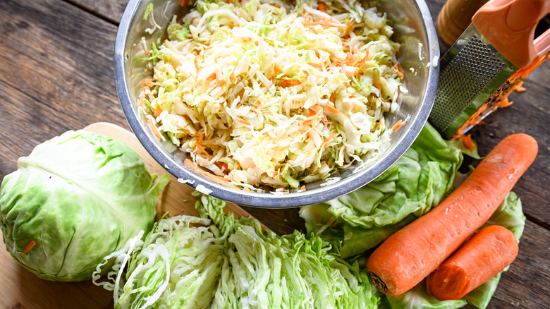 Ingredients for coleslaw on a wooden countertop