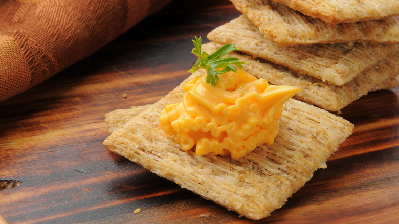 Cheddar cheese spread on a triscuit.