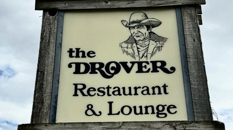 The Drover sign against a cloudy sky.