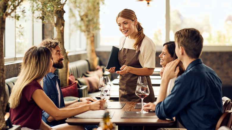 Server speaking to diners