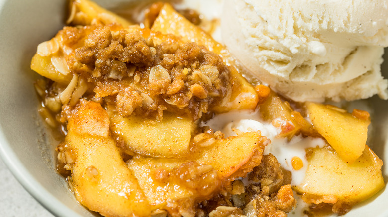 Bowl of apple crisp with vanilla ice cream