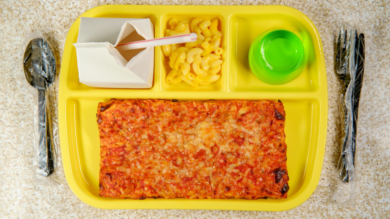 School lunch tray with milk, mac and cheese, green gelatin, and pizza