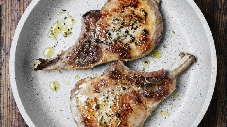Seasoned pork chops in a frying pan