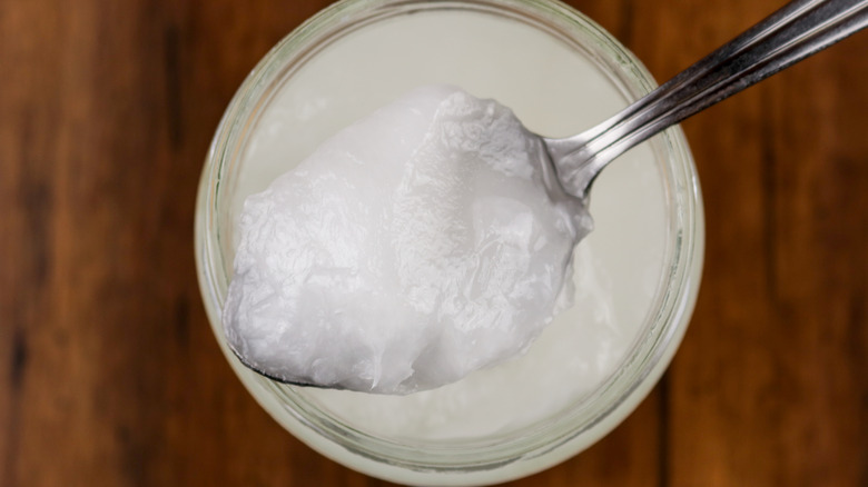 A spoonful of coconut oil from the jar