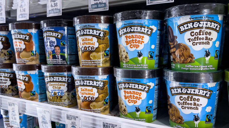 Various flavors of Ben & Jerry's stacked in a freezer.