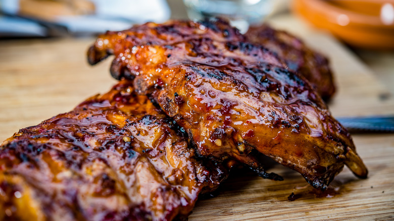 Pork ribs on a wooden plate.