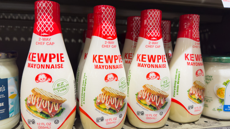 A row of Kewpie mayonnaises on a grocery store shelf