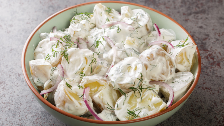 Creamy potato salad in a white bowl.