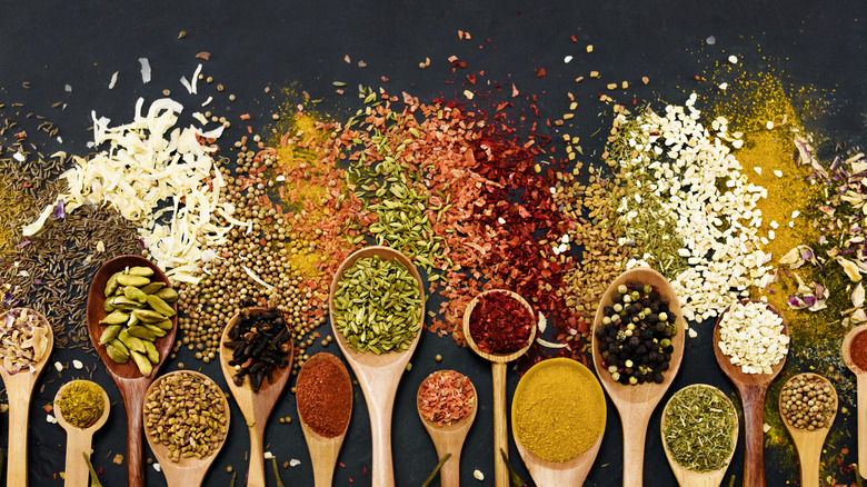 Assorted seasonings and wooden spoons