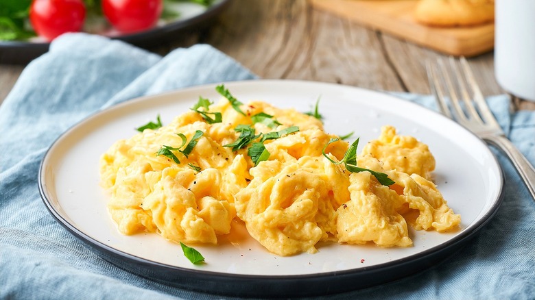 Scrambled eggs garnished with basil.