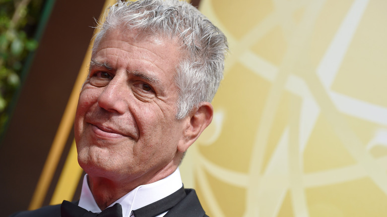 Anthony Bourdain smiling away from the camera