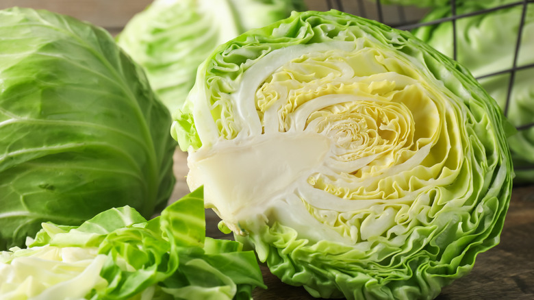 Whole and halved cabbages in close-up.