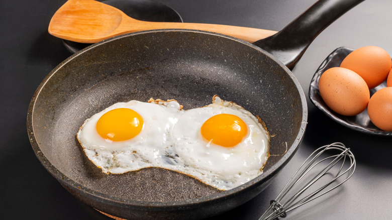 two fried eggs in a nonstick pan