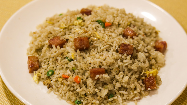 A plate of fried rice with luncheon meat.