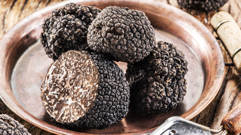 black truffles on a silver plate