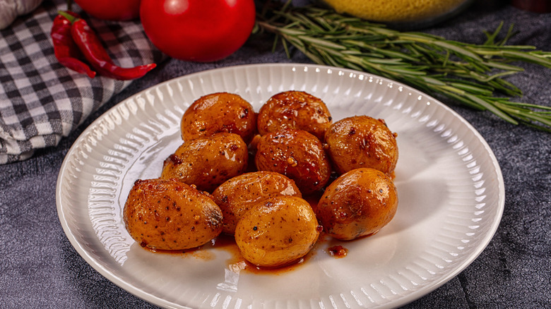 roasted new red potatoes on a white plate