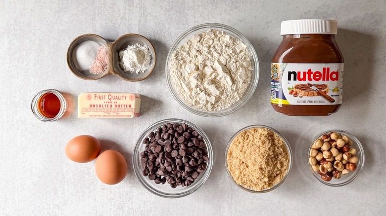 Nutella-stuffed chocolate chip cookies ingredients on countertop