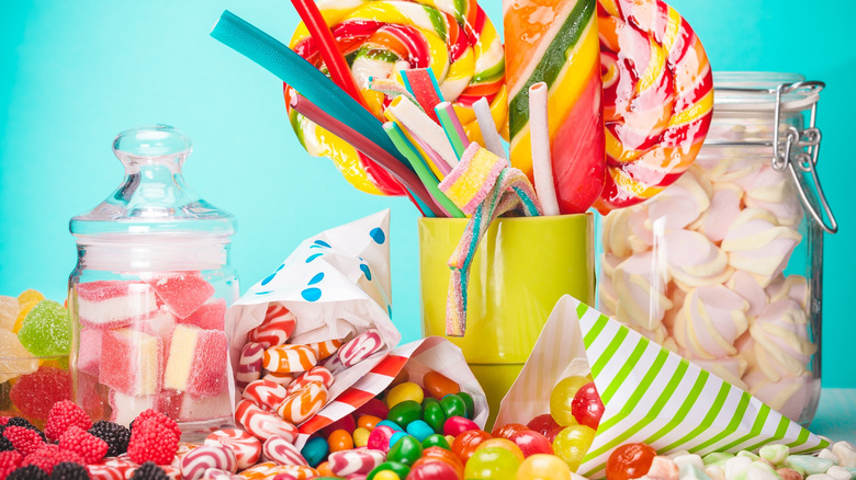 Vintage candy including lollipops, gummies, and jars on a blue background.