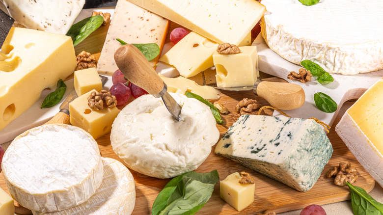 Cheese board with walnuts and basil