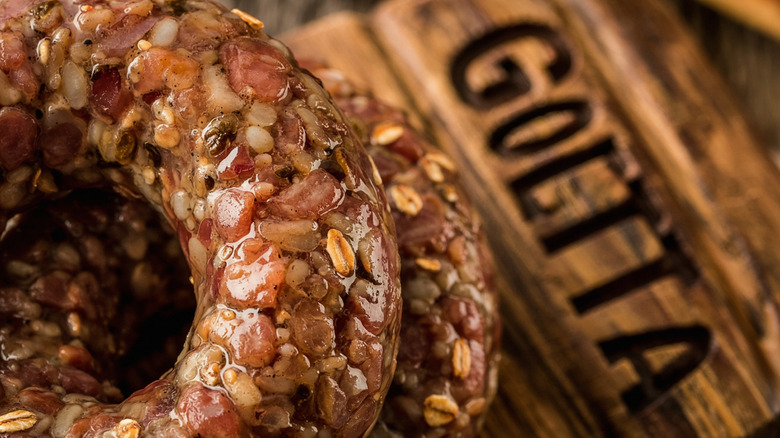 A close-up image of juicy goetta, set against a wooden background