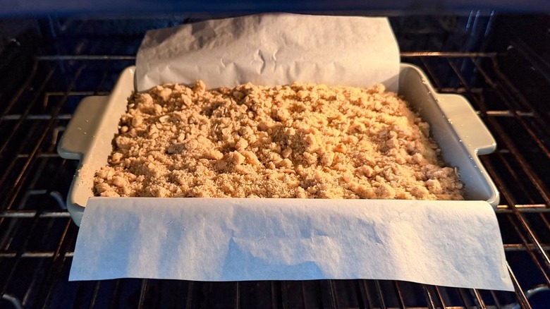 Old-fashioned blueberry crumb cake baking in oven