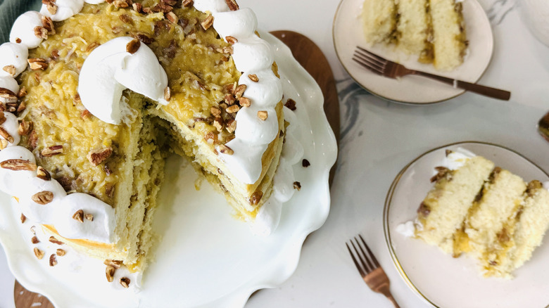 Lane cake next to slices on plates