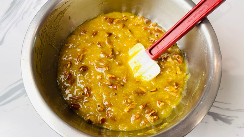 Lane cake pecan filling in bowl with rubber spatula