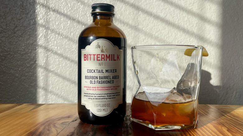 Bottle of Bittermilk Bourbon Barrel-Aged Old Fashioned with a cocktail made