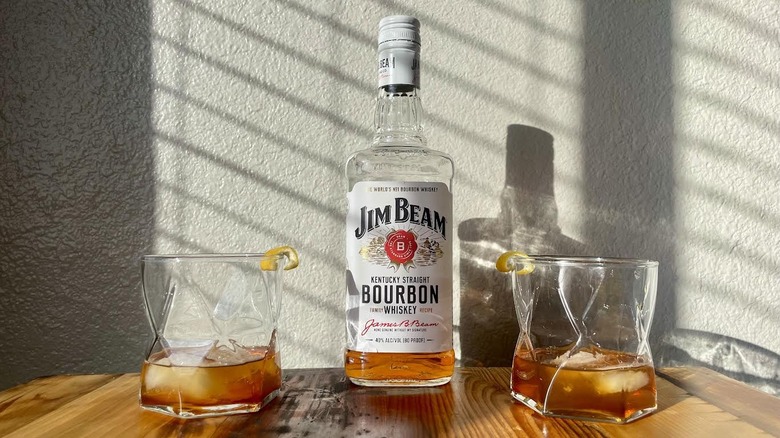 Bottle of Jim Beam Bourbon with two Old Fashioned cocktails