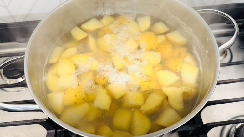 Chopped potatoes in pot of boiling water