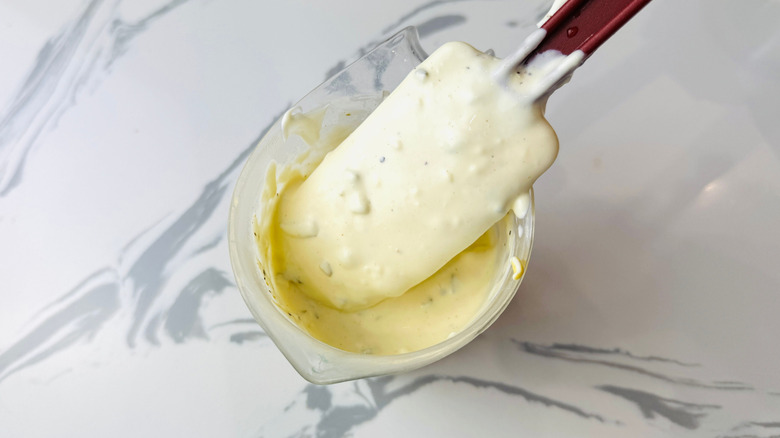 Spatula mixing creamy dressing